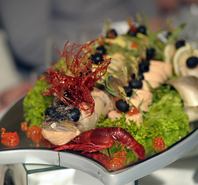 Stuffed pike with vegetables and herbs. Hearty dish in one of the bars.