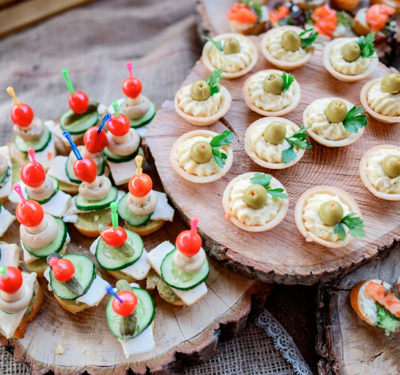 Wooden plates served with snacks of vegetables and cheese
